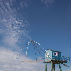 Low angle view of beach hut against blue sky