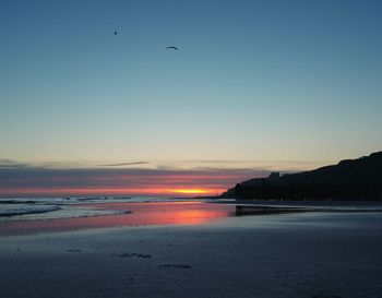 Scenic view of sea against sky during sunrise