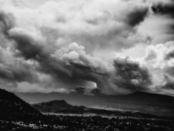 Scenic view of mountains against cloudy sky