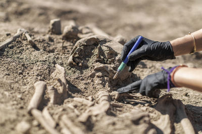 Close-up of hands working on sand