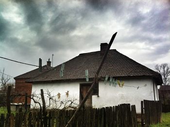 Houses against cloudy sky