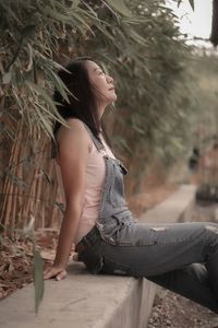 Young woman sitting on bench