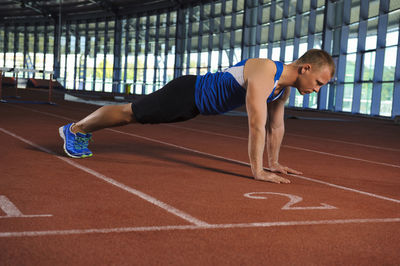 Man exercising on running track, algarve, portugal