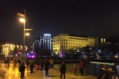 People walking in city at night