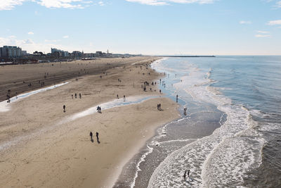 High angle view of people at beach on sunny day