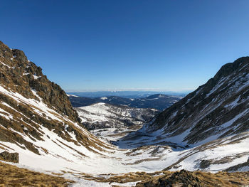 Scenic view of mountains against clear blue sky