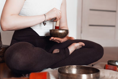 Midsection of woman using mobile phone