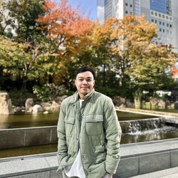 Portrait of young man standing in city