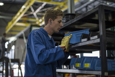 Factory worker in truck manufacture assembling truck parts