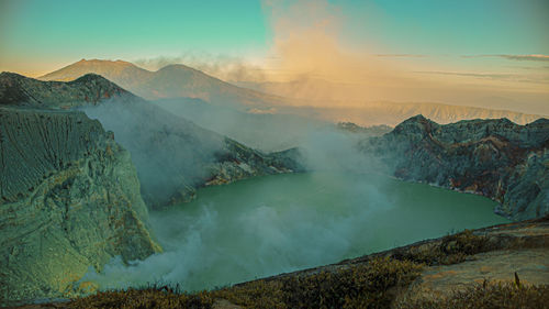 Panoramic view of volcanic landscape against sky at ijen crater volcano, indonesia. 