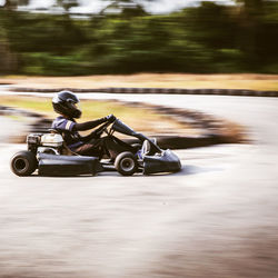 Close-up of my kids on go-cart car on training track