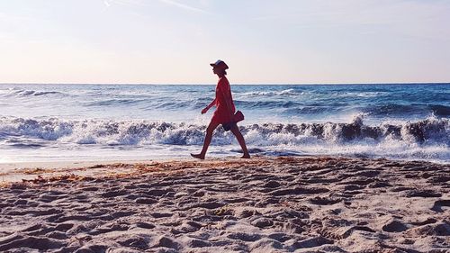 Full length of man on beach against sky