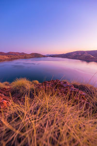 Scenic view of lake against sky during sunset