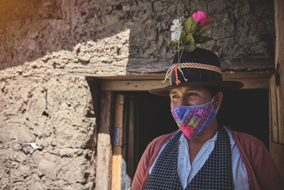 Rear view of woman standing against wall