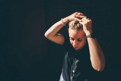 High angle view of woman with hand in hair