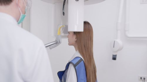 Midsection of doctor examining chemical in laboratory