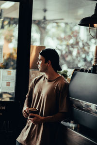 Man in cafe looking through window