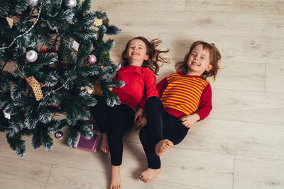 Portrait of smiling friends standing on floor