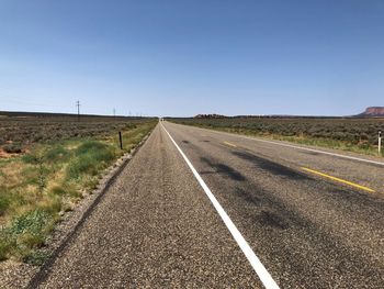 Empty road along countryside landscape