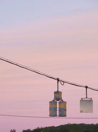 Telephone pole against sky during sunset