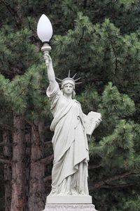 Statue against trees and plants