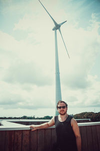 Portrait of young man wearing sunglasses against sky