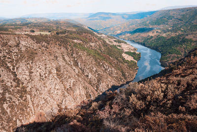 High angle view of land and mountains against sky