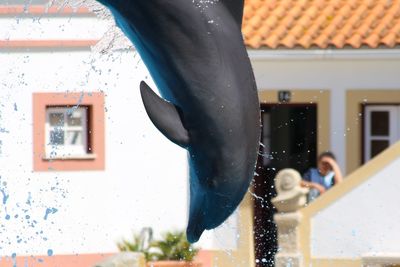 People by swimming pool against building