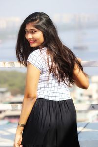 Portrait of a smiling young woman standing outdoors