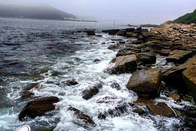 Waves splashing on rocks at shore