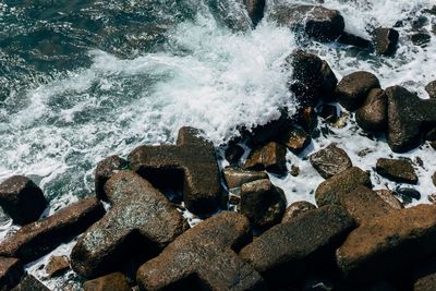 View of waves splashing on rocky beach