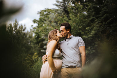 Young couple on plant against trees