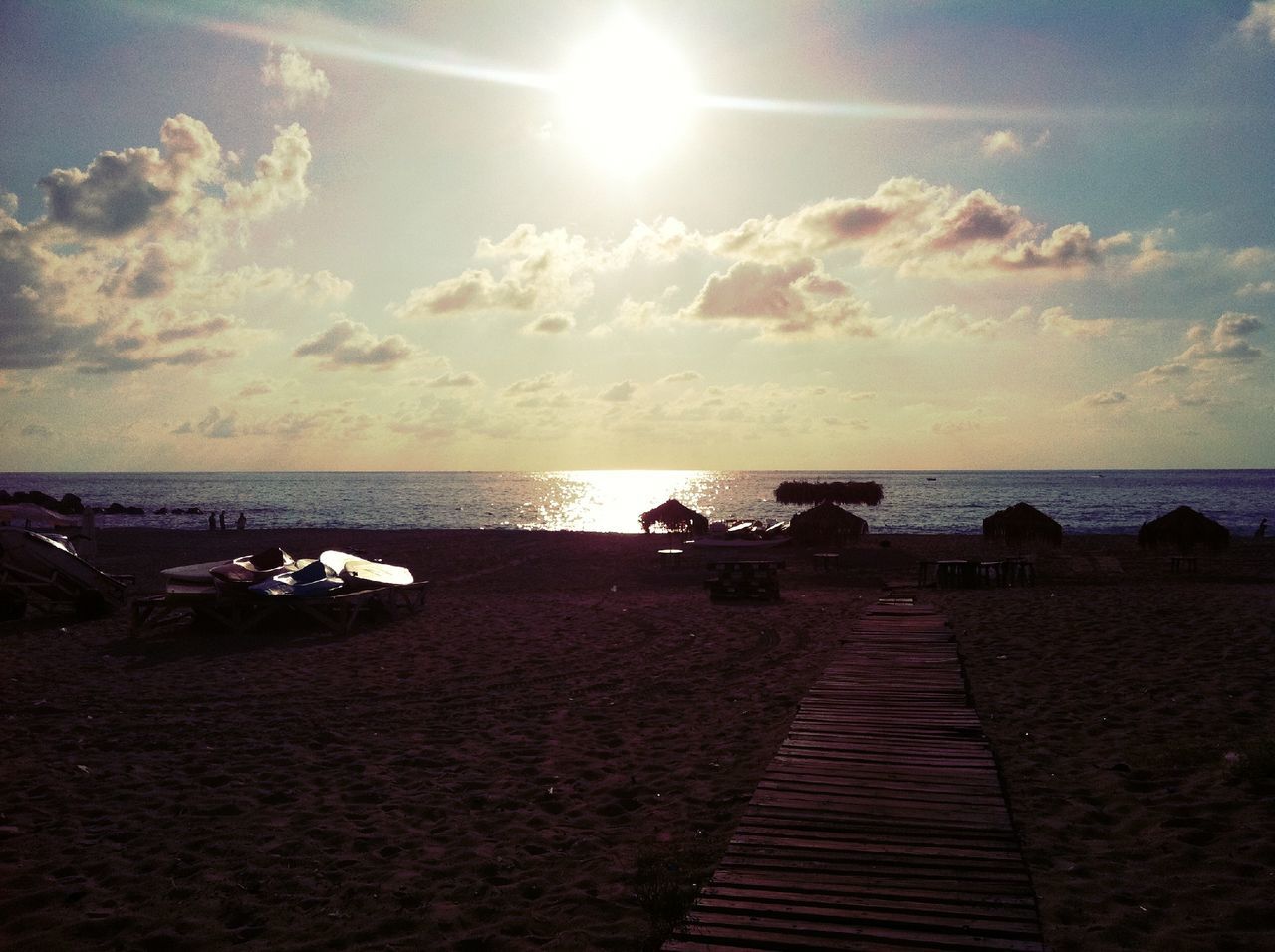 sea, horizon over water, water, sky, beach, sun, tranquil scene, tranquility, scenics, sunset, the way forward, beauty in nature, shore, sunlight, sunbeam, cloud - sky, nature, idyllic, cloud, outdoors