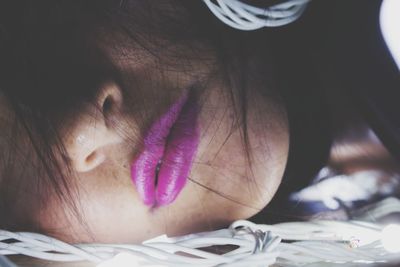 Close-up of young woman wearing purple lipstick