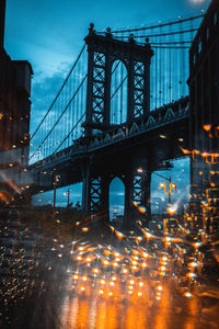Double exposure of manhattan bridge and lights at night in city