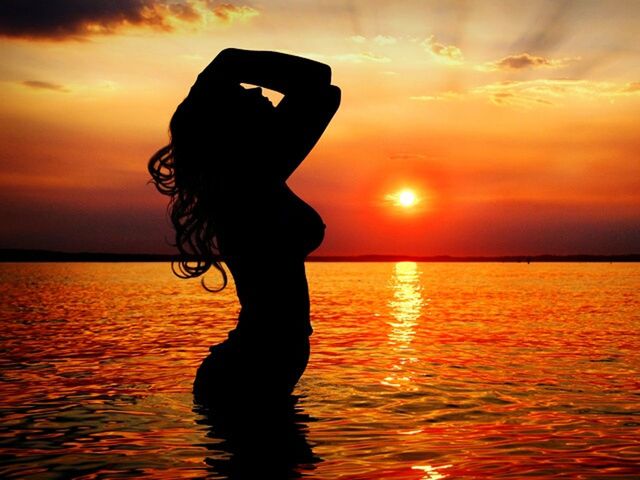 sunset, silhouette, orange color, sun, water, sea, sky, leisure activity, horizon over water, lifestyles, scenics, tranquil scene, beauty in nature, standing, tranquility, reflection, idyllic, person