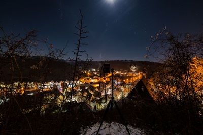 Illuminated buildings against sky at night