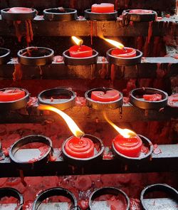 High angle view of illuminated candles in building