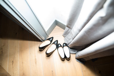 High angle view of shoes on hardwood floor