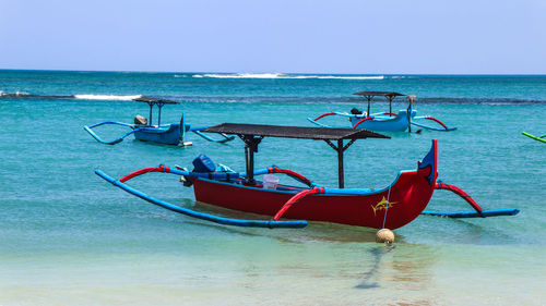 Deck chairs on beach against sky