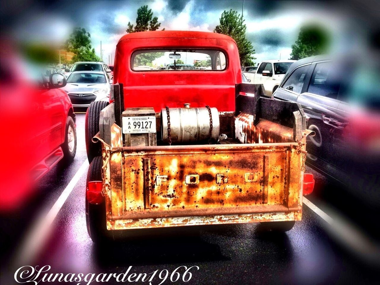 transportation, land vehicle, mode of transport, car, red, communication, text, focus on foreground, close-up, travel, old-fashioned, selective focus, western script, old, metal, retro styled, railroad track, day, tree, train - vehicle