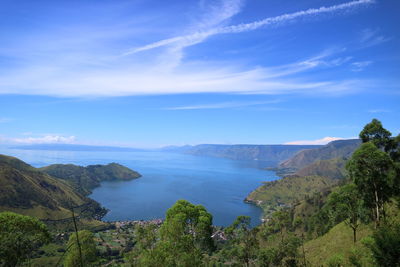 Scenic view of sea and mountains against sky