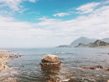 Scenic view of sea against cloudy sky