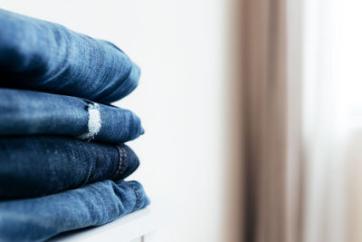 A stack of blue denim jeans or pants. textile industry concept. clothing store concept. sale concept