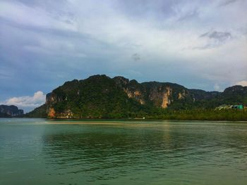 Scenic view of sea and mountains against sky