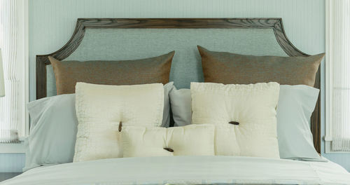 Pillows and cushions on bed at home