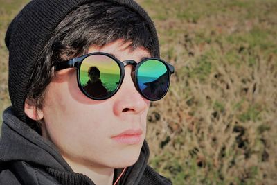 Close-up portrait of young man wearing sunglasses