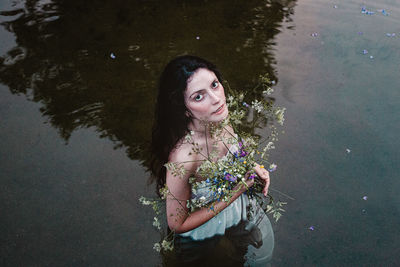 High angle portrait of woman standing in the lake