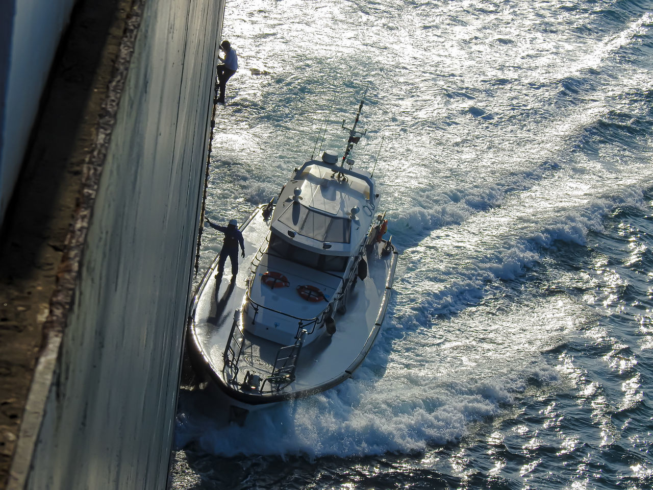 HIGH ANGLE VIEW OF SAILBOATS MOORED ON SEA