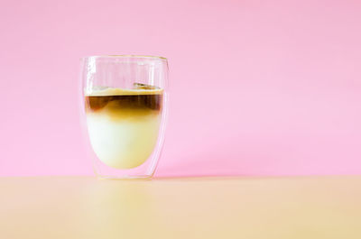 A glass that cover with some vapour of coffee mixing milk. summer drink concept.